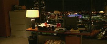 Movie still from “Collateral” (2004), directed by Michael Mann – An office desk with papers and papers on top of it; Wide shot, High angle