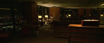 Movie still from “Collateral” (2004), directed by Michael Mann – A woman sitting at a desk in a library; Extreme Wide shot, High angle