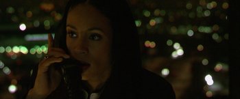 Movie still from “Collateral” (2004), directed by Michael Mann – A woman with a microphone in her mouth; Close Up shot, High angle