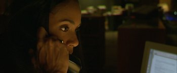 Movie still from “Collateral” (2004), directed by Michael Mann – A woman talking on a cell phone in a dark room; Extreme Close Up shot, High angle