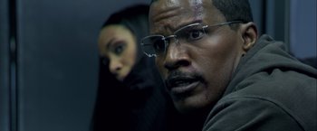 Movie still from “Collateral” (2004), directed by Michael Mann – A man and a woman are posing for a picture; Close Up shot, Over the shoulder angle
