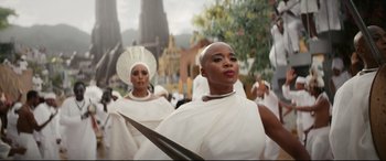 Movie still from “Black Panther: Wakanda Forever” (2022), directed by Ryan Coogler – A group of women in white dresses and headpieces; Medium shot, Low angle