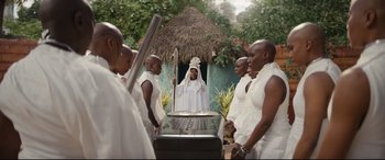 Movie still from “Black Panther: Wakanda Forever” (2022), directed by Ryan Coogler – A group of men standing next to a casket; Wide shot, High angle