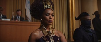 Movie still from “Black Panther: Wakanda Forever” (2022), directed by Ryan Coogler – A woman in a purple dress and a gold headpiece; Close Up shot, Low angle