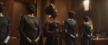 Movie still from “Black Panther: Wakanda Forever” (2022), directed by Ryan Coogler – A group of women standing next to each other in a room; Medium shot, Low angle
