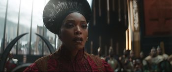 Movie still from “Black Panther: Wakanda Forever” (2022), directed by Ryan Coogler – A person wearing a headdress; Close Up shot, Over the shoulder angle