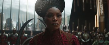 Movie still from “Black Panther: Wakanda Forever” (2022), directed by Ryan Coogler – A person wearing a hat; Close Up shot, Over the shoulder angle