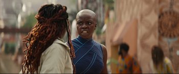 Movie still from “Black Panther: Wakanda Forever” (2022), directed by Ryan Coogler – Two women talking on the side of the street; Close Up shot, Over the shoulder angle