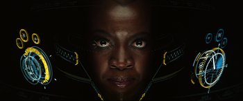 Movie still from “Black Panther: Wakanda Forever” (2022), directed by Ryan Coogler – A woman's face with yellow and black accents; Close Up shot, Overhead angle