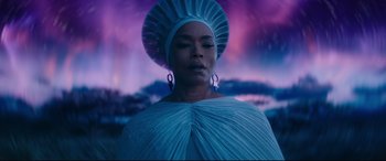 Movie still from “Black Panther: Wakanda Forever” (2022), directed by Ryan Coogler – A woman in a blue dress and a white hat; Medium shot, Low angle