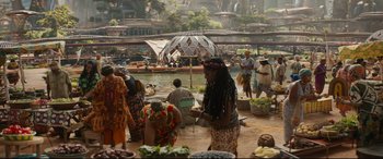 Movie still from “Black Panther: Wakanda Forever” (2022), directed by Ryan Coogler – A group of people standing next to a body of water; Extreme Wide shot, High angle