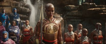 Movie still from “Black Panther: Wakanda Forever” (2022), directed by Ryan Coogler – A woman in a costume holding a sword; Medium shot, Over the shoulder angle