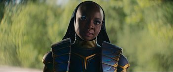 Movie still from “Black Panther: Wakanda Forever” (2022), directed by Ryan Coogler – A woman in a blue and yellow costume; Close Up shot, Over the shoulder angle