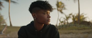 Movie still from “Black Panther: Wakanda Forever” (2022), directed by Ryan Coogler – A person wearing a black shirt; Close Up shot, Over the shoulder angle
