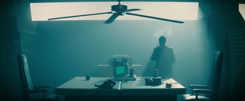 Movie still from “Blade Runner” (1982), directed by Ridley Scott – A man standing in front of a computer monitor; Wide shot, Over the shoulder angle