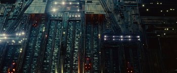 Movie still from “Blade Runner” (1982), directed by Ridley Scott – An aerial view of a train yard at night; Extreme Wide shot, Low angle