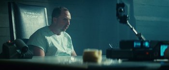 Movie still from “Blade Runner” (1982), directed by Ridley Scott – A man sitting at a table in front of a candle; Close Up shot, Low angle
