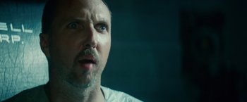 Movie still from “Blade Runner” (1982), directed by Ridley Scott – A person looking at the camera; Close Up shot, Low angle