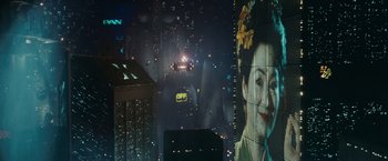 Movie still from “Blade Runner” (1982), directed by Ridley Scott – A view of a city at night from a window; Extreme Wide shot, Over the shoulder angle