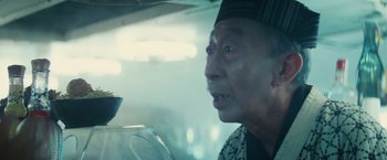 Movie still from “Blade Runner” (1982), directed by Ridley Scott – An older man in a black and white hat looking into a mirror; Close Up shot, Over the shoulder angle