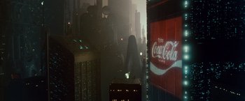 Movie still from “Blade Runner” (1982), directed by Ridley Scott – A woman in a long black dress standing in the middle of a city; Extreme Wide shot, Low angle