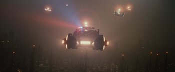 Movie still from “Blade Runner” (1982), directed by Ridley Scott – A car is flying through the air at night; Extreme Wide shot, Low angle