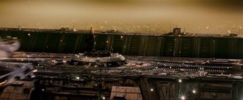 Movie still from “Blade Runner” (1982), directed by Ridley Scott – An aerial view of a city at night with lights; Extreme Wide shot, Overhead angle