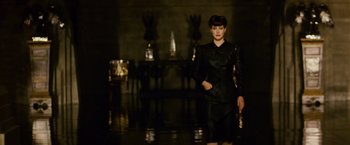 Movie still from “Blade Runner” (1982), directed by Ridley Scott – A woman in a black outfit standing in front of a mirror; Medium shot, Low angle