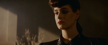 Movie still from “Blade Runner” (1982), directed by Ridley Scott – A person wearing a necklace; Close Up shot, Low angle