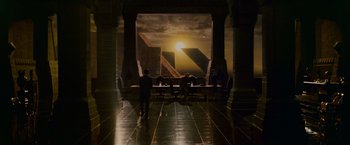 Movie still from “Blade Runner” (1982), directed by Ridley Scott – A group of people sitting at a table in front of a building; Extreme Wide shot, High angle