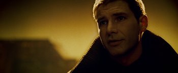 Movie still from “Blade Runner” (1982), directed by Ridley Scott – A man's face in the dark; Close Up shot, Over the shoulder angle