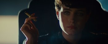 Movie still from “Blade Runner” (1982), directed by Ridley Scott – A person holding a piece of food; Close Up shot, Over the shoulder angle