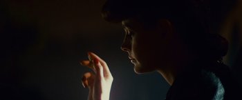 Movie still from “Blade Runner” (1982), directed by Ridley Scott – A woman holding a cigarette in her hand; Close Up shot, Over the shoulder angle