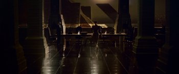 Movie still from “Blade Runner” (1982), directed by Ridley Scott – A group of people sitting at a table in a dark room; Extreme Wide shot, High angle