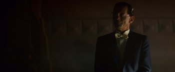 Movie still from “Blade Runner” (1982), directed by Ridley Scott – A man in a tuxedo standing in a dark room; Close Up shot, Low angle