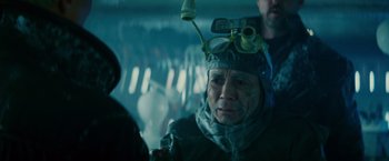 Movie still from “Blade Runner” (1982), directed by Ridley Scott – An older man wearing goggles and a helmet; Close Up shot, Over the shoulder angle