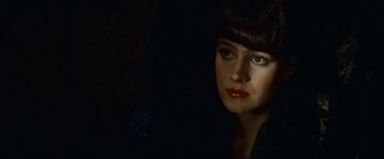 Movie still from “Blade Runner” (1982), directed by Ridley Scott – A beautiful woman with red lipstick looking at the camera; Close Up shot, Low angle