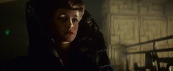 Movie still from “Blade Runner” (1982), directed by Ridley Scott – A young woman wearing a fur coat in a dark room; Close Up shot, Over the shoulder angle