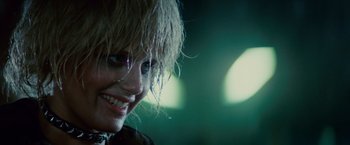 Movie still from “Blade Runner” (1982), directed by Ridley Scott – A person smiling with a blurry background; Close Up shot, Over the shoulder angle