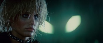 Movie still from “Blade Runner” (1982), directed by Ridley Scott – A woman's face in front of green lights; Close Up shot, Low angle