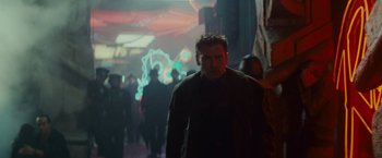 Movie still from “Blade Runner” (1982), directed by Ridley Scott – A man walking down a street at night; Medium shot, Low angle