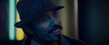 Movie still from “Blade Runner” (1982), directed by Ridley Scott – A person wearing a hat; Close Up shot, Over the shoulder angle