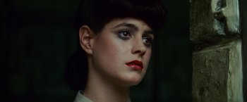 Movie still from “Blade Runner” (1982), directed by Ridley Scott – A person wearing a white shirt and red lipstick; Close Up shot, Low angle