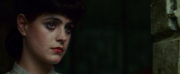 Movie still from “Blade Runner” (1982), directed by Ridley Scott – A person wearing a hat; Close Up shot, Over the shoulder angle