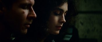 Movie still from “Blade Runner” (1982), directed by Ridley Scott – A woman's face in a dark room; Close Up shot, Over the shoulder angle