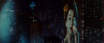 Movie still from “Blade Runner” (1982), directed by Ridley Scott – A picture of a woman in a kimono on the side of a building; Extreme Close Up shot, Low angle