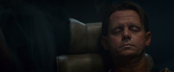 Movie still from “Blade Runner” (1982), directed by Ridley Scott – A man sitting in a chair with his head resting on a pillow; Close Up shot, High angle