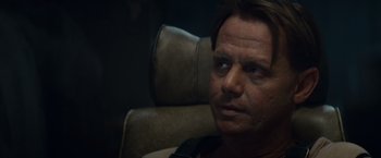 Movie still from “Blade Runner” (1982), directed by Ridley Scott – A person sitting in a chair; Close Up shot, Over the shoulder angle