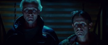 Movie still from “Blade Runner” (1982), directed by Ridley Scott – Two men are standing next to each other; Close Up shot, Low angle