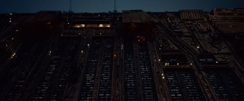 Movie still from “Blade Runner” (1982), directed by Ridley Scott – A view of a building at night from the ground level; Extreme Wide shot, Low angle